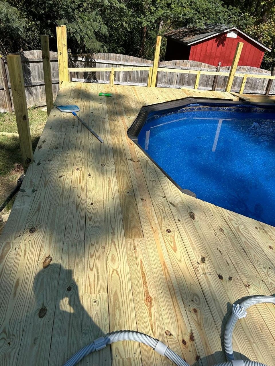 Backyard with wooden fence and pool deck