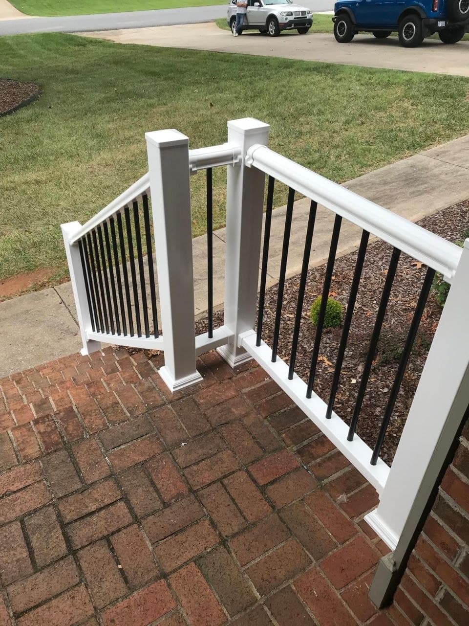 Finished railing at brick porch steps